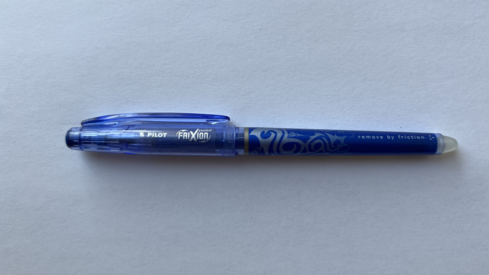 Blue Pilot FriXion erasable pen with decorative swirls on white background