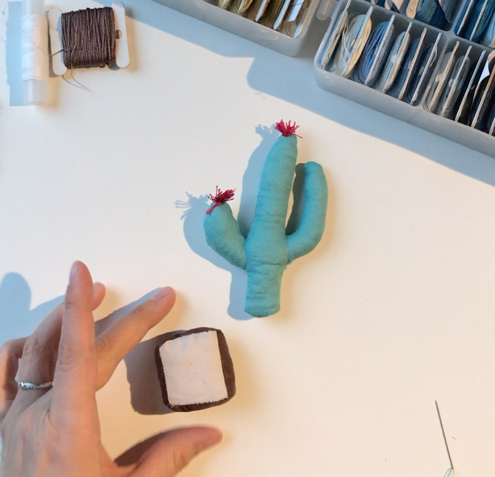 Sewed and filled cactus and pot on the table