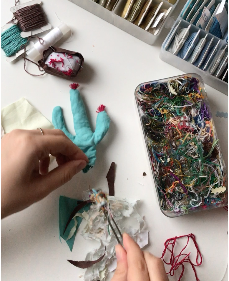 Filling the cactus with thread scraps using tweezers